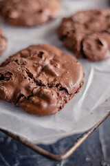 Choco chip cookies on unbleached parchment paper.  Cookies with chocolate on baking paper. Close up. Copy space
