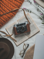 Retro camera, notepad, cup of coffee, hat, glasses, book and flowers on a white background. Romantic style.