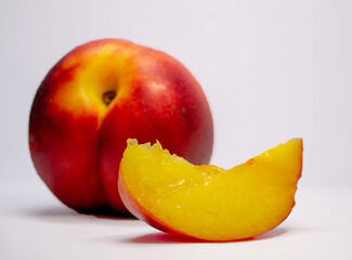 red and yellow nectarine on white background