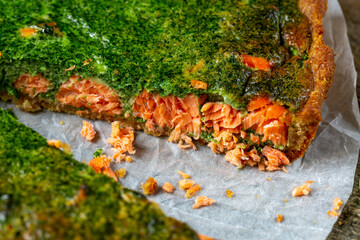 .Appetizing quiche pie with fish and spinach