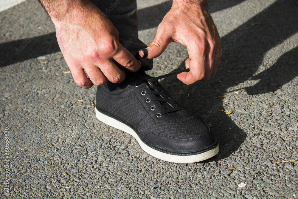 Wall mural man runner ties shoe laces