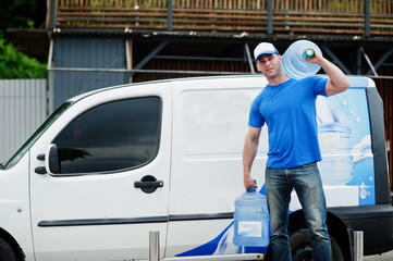 Delivery men in front cargo van delivering bottles of water.