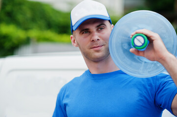 Delivery man in front cargo van delivering bottles of water.