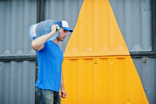 Delivery Man Carrying Water Bottle On Shoulder.