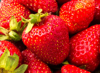 Closeup of strawberries in a box, isolated on a white background