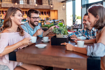 Group of friends meeting in coffee shop.
