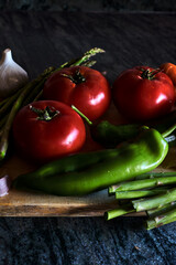 Vegetable still life with tomatoes, peppers, garlic and asparagus