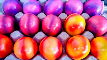 Closeup of colorfully decorated easter eggs in purple, pink, orange and red