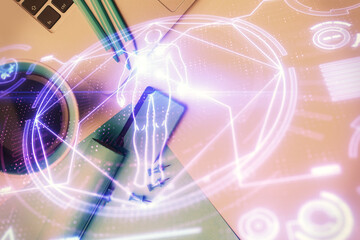 Education hologram drawings over computer on the desktop background. Top view. Multi exposure.