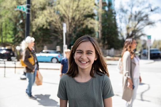 Portrait Happy Girl Laughing On City Sidewalk