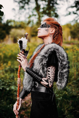 Girl in ethnic scandinavian costume in the forest