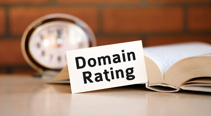 Domain rating concept text on a white background with a clock and an open book