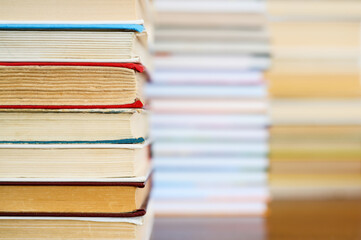 A stack of old books lies in the foreground. In the background, Kingy's are blurry