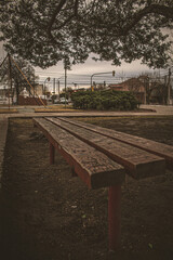 wooden bench of a square on a cloudy day