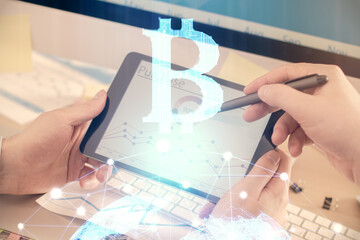Double exposure of man's hands holding and using a phone and crypto currency blockchain theme...