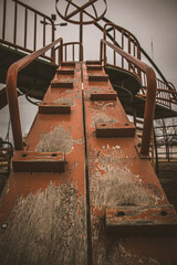 
large metal and wood slide of various colors such as blue, red, orange and yellow