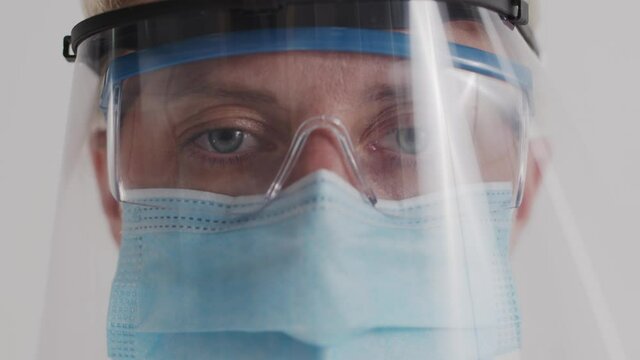 Research Laboratory Officer. 2019 Novel Coronavirus (2019-nCoV), COVID-19 concept. Close-up of a female doctor's eyes through a protective mask and medical glasses during work