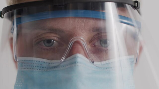 Research Laboratory Officer. 2019 Novel Coronavirus (2019-nCoV), COVID-19 concept. Close-up of a female doctor's eyes through a protective mask and medical glasses during work