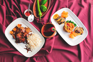 Beef with vegetables in soy sauce with cooked rice. A dish on a red background. A spicy dish of...