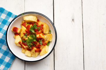 Spanish fried potatoes with sauce also called patatas bravas on white background