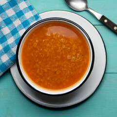 Alphabet soup pasta on turquoise background