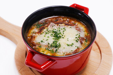 French onion soup with gruyere cheese melted crouton in a serving pot