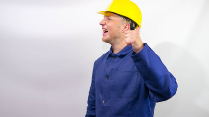 Young and cheerful builder on a white background,smiling worker.Builder in a helmet