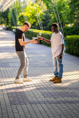 Obraz premium A black guy and a white guy meet and greet each other in an original way. Interracial friendship