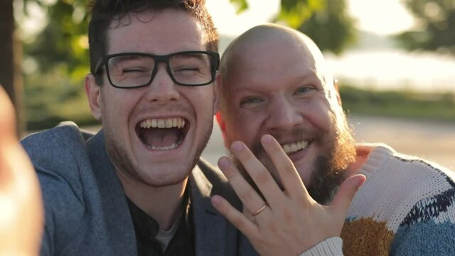 Cute Gay Couple Pose For Selfie With wedding ring. Gay Marriage Proposal Concept. Adorable Boyfriend Gifts a Beautiful Shiny Wedding Ring.