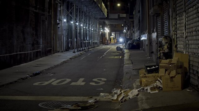 New York City dark abandoned narrow street by night, Manhattan gloomy cityscape
