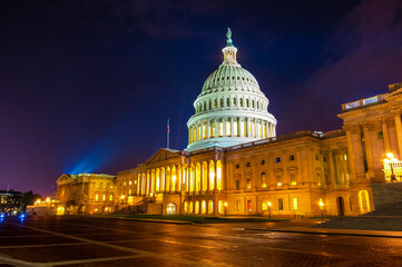 Architectural light illuminate mall and marble dome on the east side entrance of United States capitol building at night in Washington DC in summer