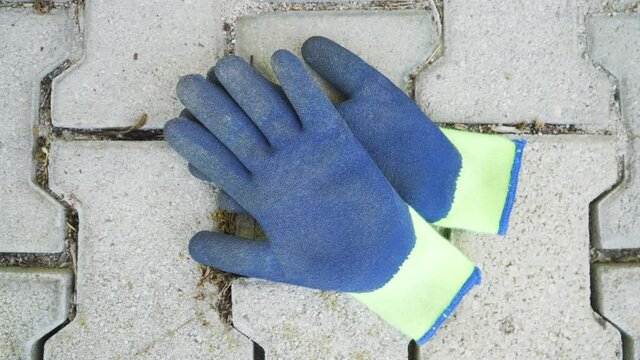 Construction protective working gloves on the ground, static shot.