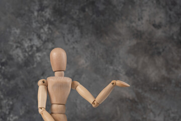 Handcrafted wooden man figure mannequin model dummy doll on background. Copy space.