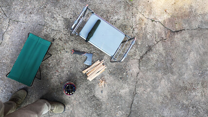 Concrete platform on which items for using a portable windproof stove in the outdoor. Top view of the first person in a flat lay