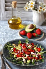 salad with strawberries and avocado, arugula, feta cheese, pumpkin seeds, red onion. dressed with balsamic sauce