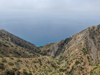 Fototapeta premium Aerial view of Santa Catalina Island mountains and trails with ocean on the background. California, USA