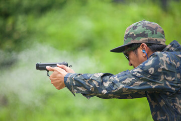 Fototapeta premium law enforcement aim pistol by two hand in academy shooting range in flare