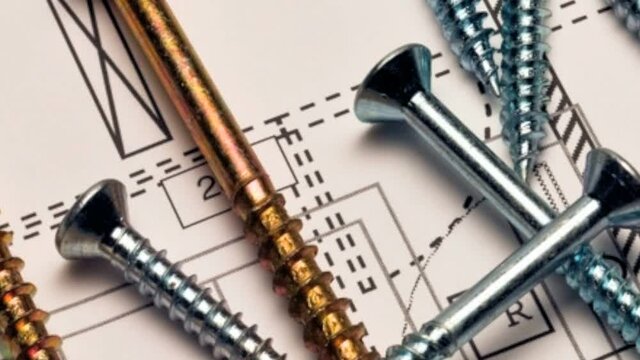 Assorted screws on a blueprint