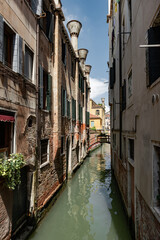 Fototapeta na wymiar Canals of Venice during the day in high resolution, vertical