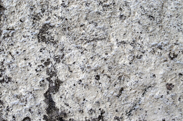 cement-stone wall of an old construction site whitewashed by lime and worn out by time