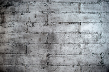 concrete wall consisting of large blocks fastened with reinforcing bars and cement painted with gray paint1