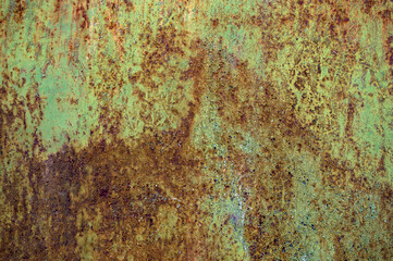 old worn iron sheet with multi-colored exfoliated scratched paint with different shades of orange