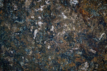 texture of a large mountain heavy stone with different colors with an unusual relief with yellow dots