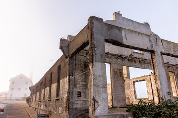 Alcatraz island and prison exterior at dusk showing ruins and fog