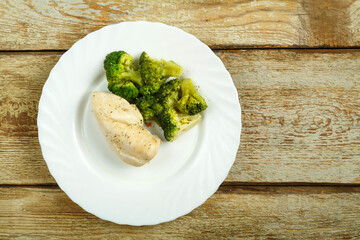 Diet slimming boiled broccoli and chicken breast on a plate.