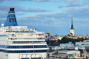 Passenger ship (cruise liner) anchored in port of Tallinn, Estonia. Baltic sea. Buildings and...