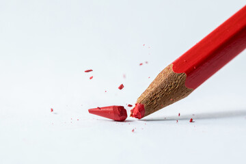 broken red pencil stub in white background.  - Powered by Adobe