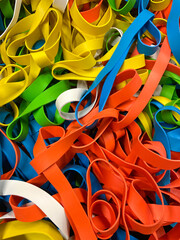 Rubber ribbon of different colors collected in a single background