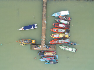 Aerial shot of tourism and fishing boats anchored at a jetty