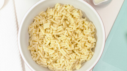 Cooked pasta close up in a bowl, view from above